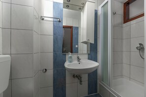 A bathroom with a white sink, a mirror, and a shower. - Villa Iva, Krmed, Croatia (Krmed)