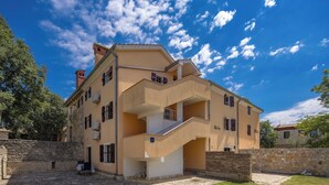 A multi-story building with a stone facade, a central staircase, and a small balcony. - Istrian Countryside House Iva, Rovinj-Krmed, Croatia (Krmed)