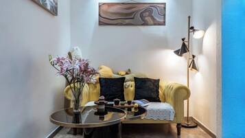 A living room with a sofa, a coffee table, and a floor lamp.