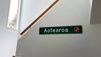 A sign reading "Aotea" with a red shield emblem on a white wall.