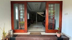 A building entrance with a staircase leading to a living area. - KODAI FOGGY (Kodaikanal)