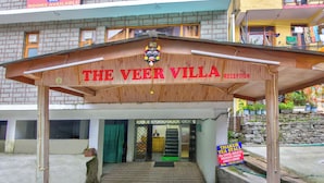 The entrance to The Veer Villa with a reception area and a staircase leading up. - The Veer Villa (Manali)