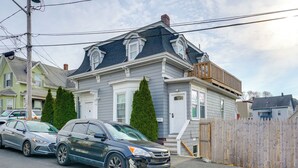 A residential street with houses and parked cars. - Apt in Historic Lynn Neighborhood: 5 Mi to Salem! (Lynn)