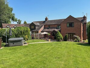 A two-story brick house with a well-maintained lawn and a patio area. - 3 bedroom accommodation in Areley Kings, Near Stourport on Severn (Areley Kings, Near Stourport on Severn)