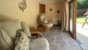 A cozy living room with a sofa, armchair, and a small table with a decorative item. - 3 bedroom accommodation in Areley Kings, Near Stourport on Severn (Areley Kings, Near Stourport on Severn)