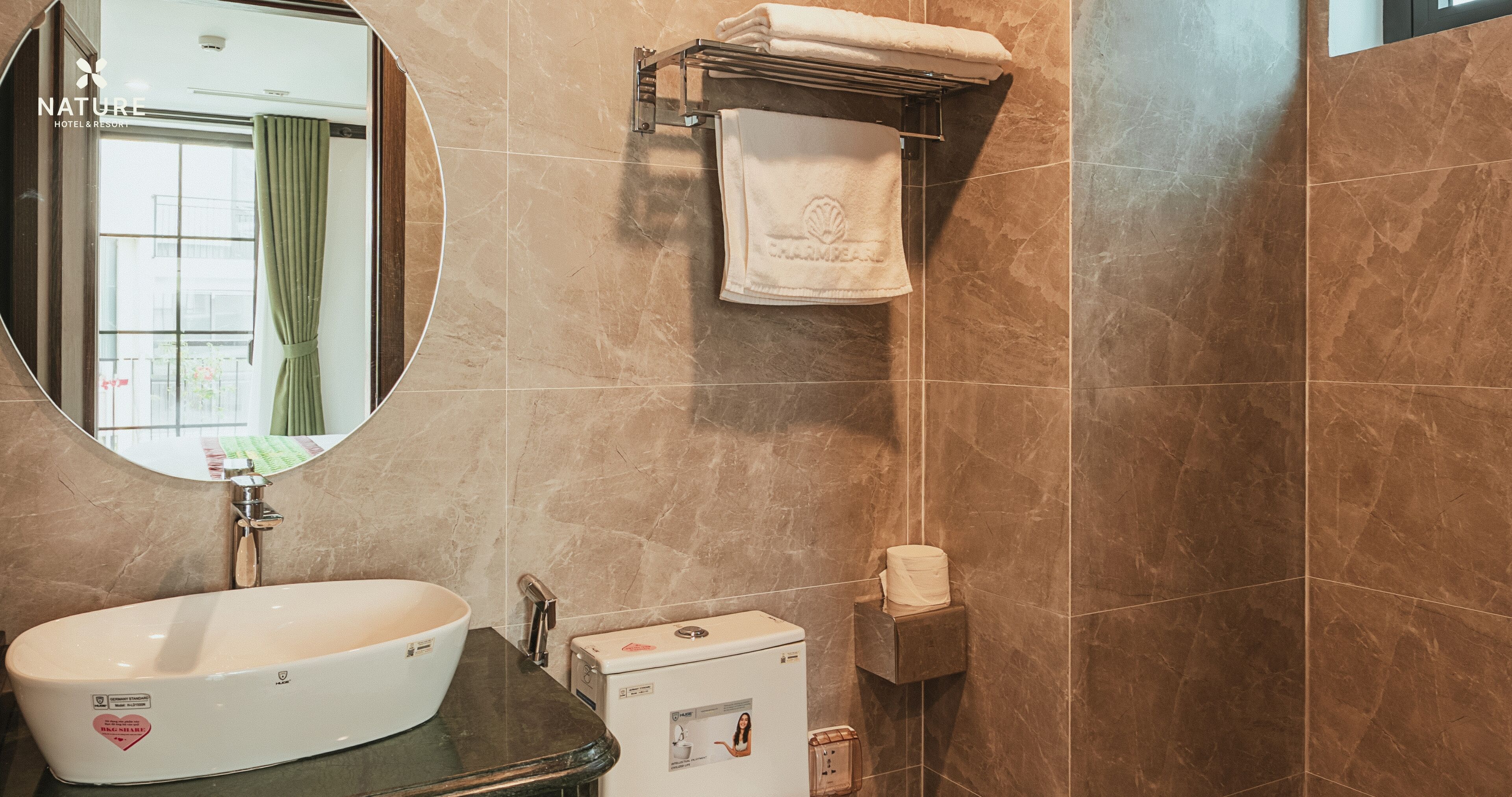 A bathroom with a sink, mirror, towel rack, and toilet.