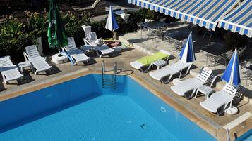 Seasonal outdoor pool, open 9:00 AM to 7:00 PM, pool umbrellas