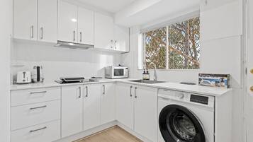 Fridge, microwave, stovetop, cookware/dishes/utensils