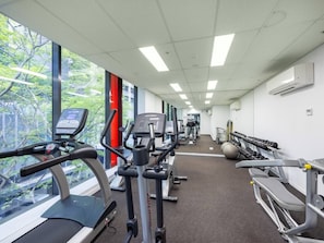 A gym with treadmills, stationary bikes, and weight machines. - Prime CBD Stay | Walk to Queen St Mall | 1 Parking (Brisbane City)