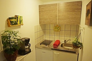 Fridge, stovetop, coffee/tea maker, cookware/dishes/utensils