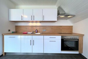 Een koelkast, een oven, een kookplaat, een vaatwasser