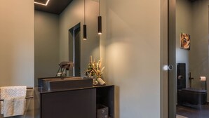 A modern bathroom with a dark vanity, a towel rack, and a mirror. - Nettes Ferienhaus mit Privatem Pool by Interhome (Varna)