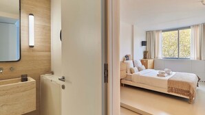 Een moderne slaapkamer met een bed, nachtkastje en een raam met gordijnen.