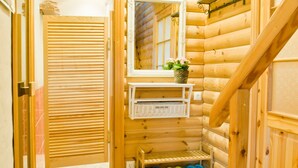A wooden interior with a sliding door, a mirror, a shelf with shoes, and a small plant. - mit eigenem Parkplatz by Interhome (Ulbroka)
