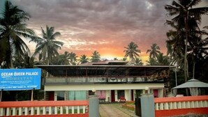 A two-story building with a sign for Ocean Queen Palace Homestay. - Ocean Queen Palace Poovar – Double Room with Refreshing Pool Views (Poovar)