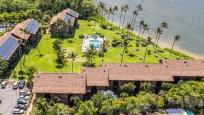 An aerial view of a resort with multiple buildings, a swimming pool, and a beach. - Ocean Views W/Ground Lanai and Kitchen-Molokai Shores (Kaunakakai)