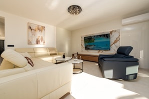 Luxury Villa, Partial Sea View | Living area | 100-cm Smart TV with satellite channels