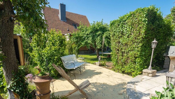 A garden with a bench, a table, and a lamp post. - Geiserich by Interhome (Blankenburg)