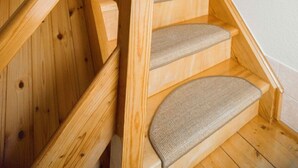 A wooden staircase with a handrail and carpeted steps. - Geiserich by Interhome (Blankenburg)