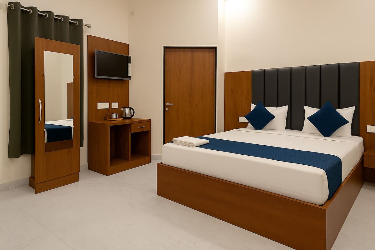 A hotel room with a bed, a TV, a desk, and a wardrobe.