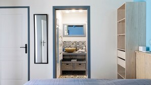A bathroom with a sink, mirror, and shelves. - Holiday Home “Le Gîte Aïdan” with Shared Garden and Wi-Fi (LA PUYE)