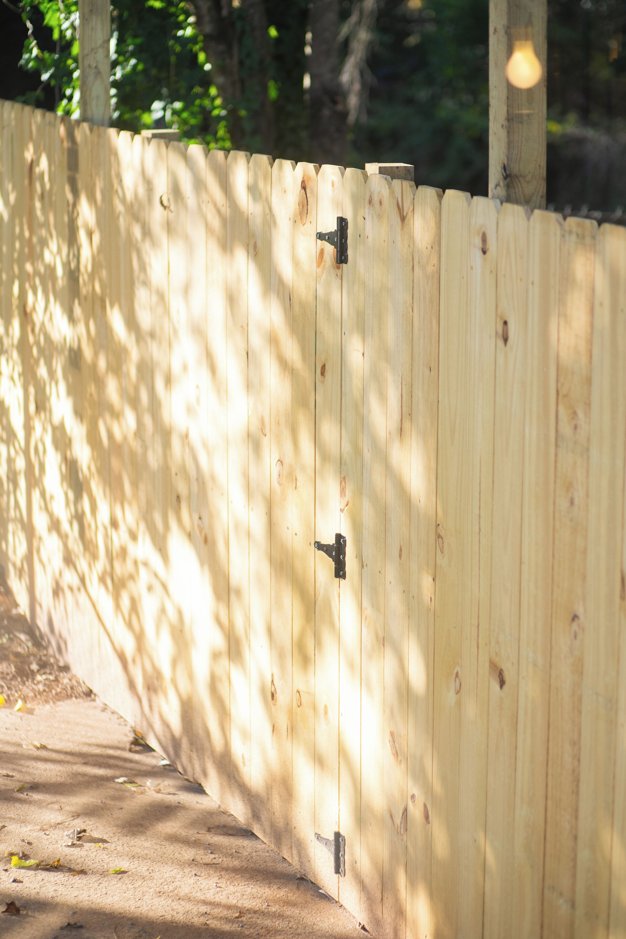 A wooden fence with a metal latch.
