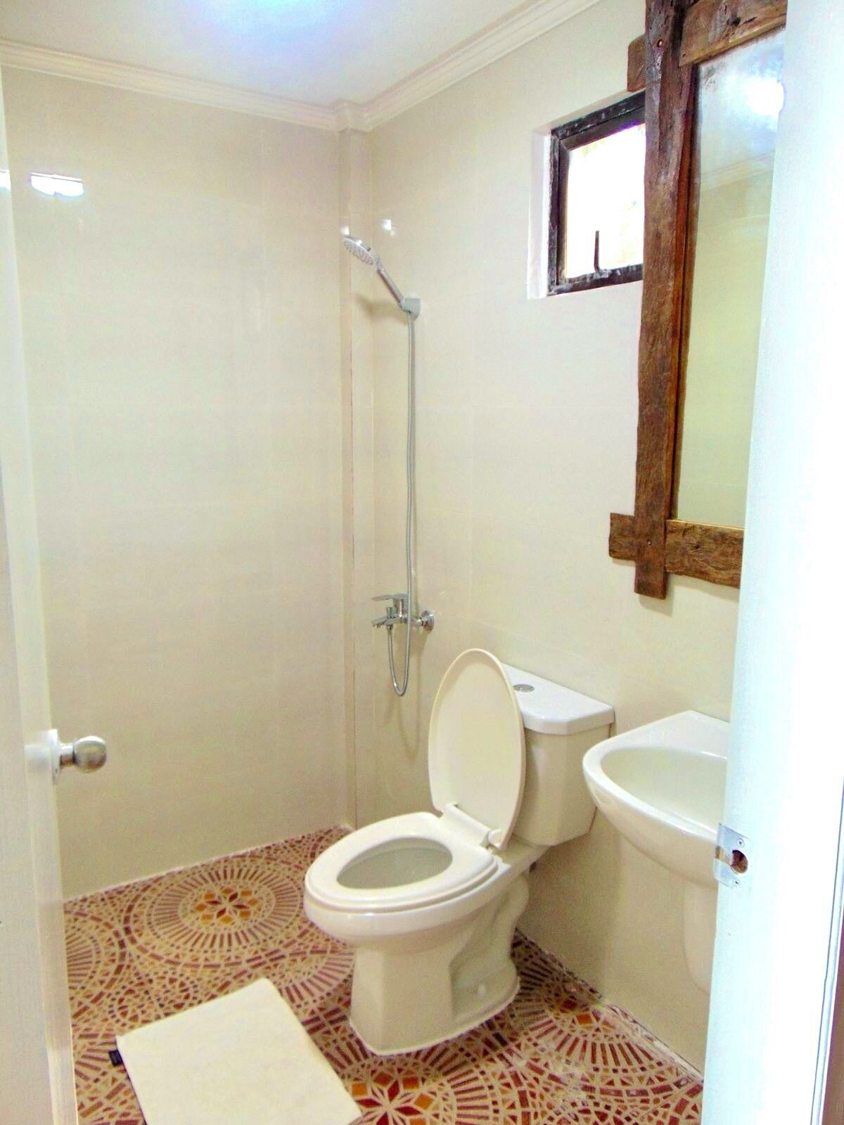 A bathroom with a shower, toilet, and sink.
