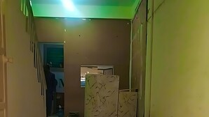 A hallway with a tiled floor, a staircase on the left, and a door at the end. - Hotel The Prime (Rawalpindi)