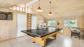 A ping pong table in a room with wooden walls, a dartboard, and a foosball table. - VillaVilla 159 - Østersøbadet, Lolland/Falster/Møn (Rødby)
