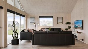 A modern living room with a black leather sofa, a cactus plant, and artwork on the walls. - VillaVilla 392 - Faaborg, Fyn og øer (Faaborg)