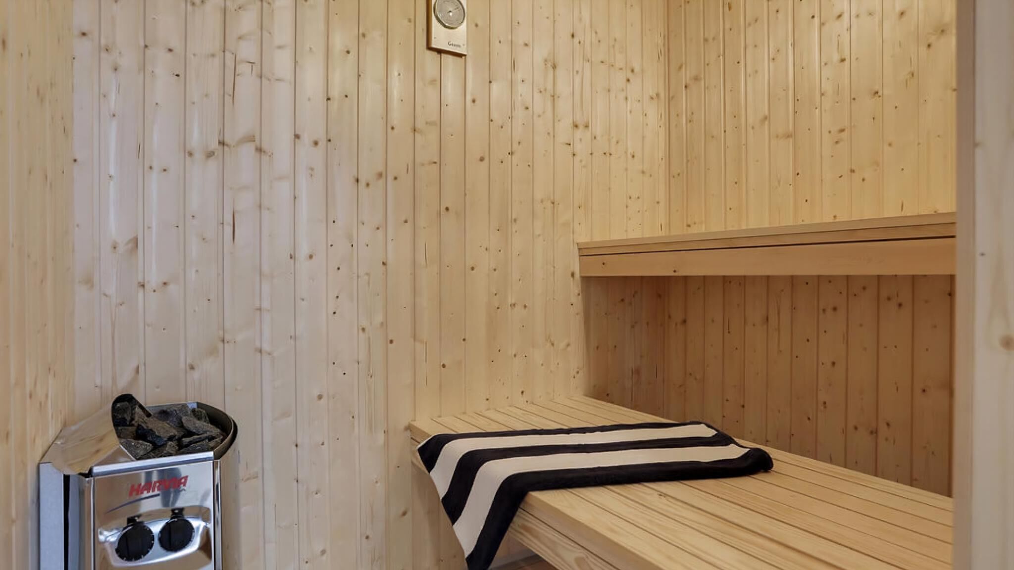 A sauna room with wooden walls and benches.