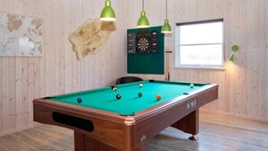 A pool table with balls, a dartboard, and a mounted animal hide on the wall. - VillaVilla 283 - Vejers, Vestjylland (Vejers Strand)