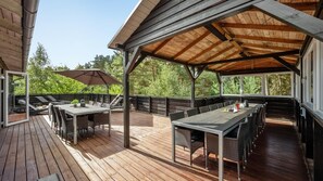 An outdoor deck with a covered seating area, a table, and chairs. - VillaVilla 247 - Ebeltoft, Østjylland (Ebeltoft)