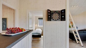 A room with a dartboard, a bed, a ladder, and a fruit platter. - VillaVilla 399 - Blåvand, Vestjylland (Blåvand)