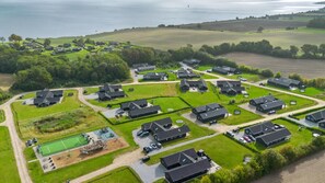An aerial view of a residential area with houses, a playground, and a sports field. - VillaVilla 531 - Mommark, Sydjylland (Sydals)