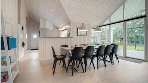 A modern dining area with a wooden ceiling, large windows, and a view of the outdoors. - VillaVilla 578 - Marielyst, Lolland/Falster/møn (Idestrup)
