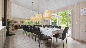 A dining area with a long table, black chairs, and woven light fixtures. - VillaVilla 313 - Henne Strand, Vestjylland (Henne)