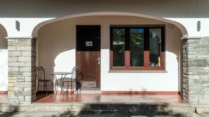 A building entrance with a stone archway, a wooden door, and a window. - Near the lake and the center (FLORIDA ASCONA Room 06) (Ascona)