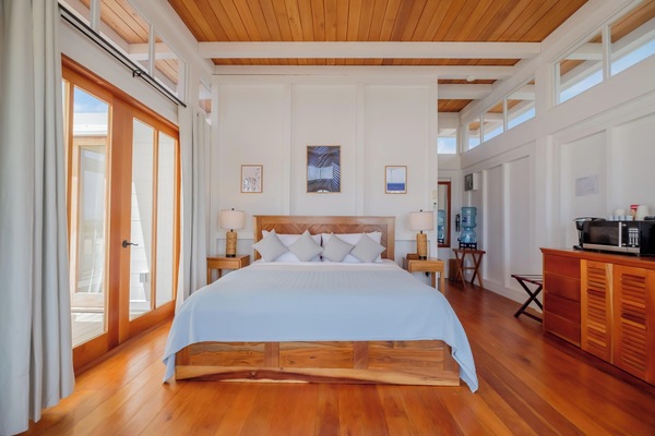 Unwind in crisp linens beneath warm wood ceilings.