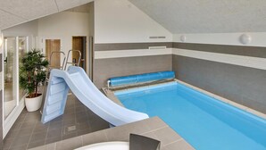 An indoor swimming pool with a slide, a potted plant, and a shower area. - VillaVilla 355 - Lohals, Fyn og øer (Tranekær)
