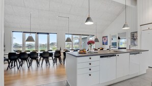 A spacious kitchen with a large island, white cabinetry, and pendant lighting. - VillaVilla 496 - Mommark, Sydjylland (Sydals)