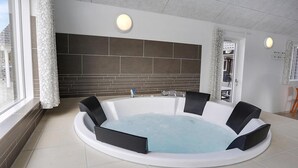 A modern bathroom with a freestanding bathtub, a large mirror, and a window with curtains. - VillaVilla 393 - Blåvand, Vestjylland (Blåvand)
