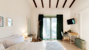 A modern hotel room with a bed, desk, chair, TV, and a view through the window. - Near the lake and the center (FLORIDA ASCONA Room 14) (Ascona)
