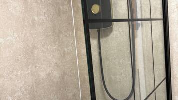 Combined shower/bathtub, deep-soaking bathtub, hair dryer, towels