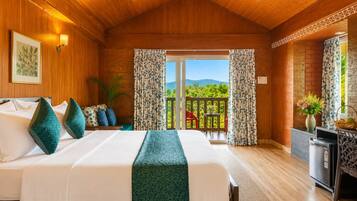 A room with a bed, a desk, a chair, and a view of greenery outside.