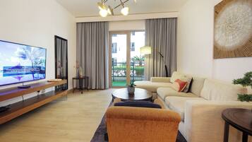 Apartment, City View | Living area | 64-inch LED TV with digital channels