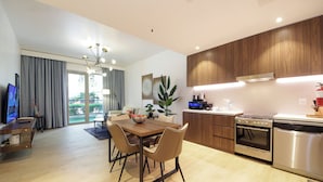 A modern kitchen with wooden cabinets, a stainless steel oven, and a dishwasher.