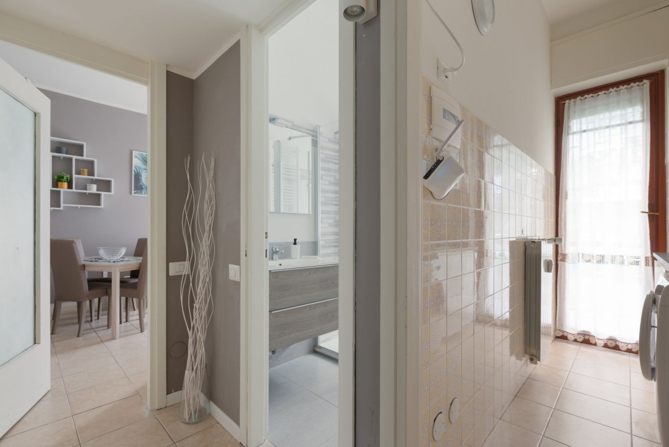 A modern bathroom with a shower, toilet, and sink.