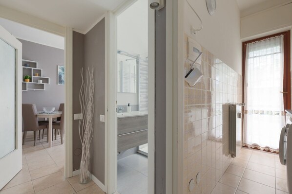 A modern bathroom with a shower, toilet, and sink.