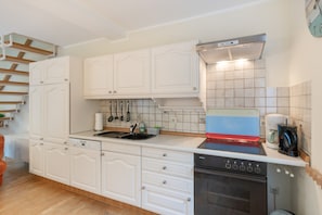 A kitchen with white cabinetry, a stainless steel sink, a Siemens dishwasher, and a Siemens oven. - Apartment 'Fewo Nordsee Whng 3' with Private Terrace, Private Garden and Wi-Fi (Wangerland)